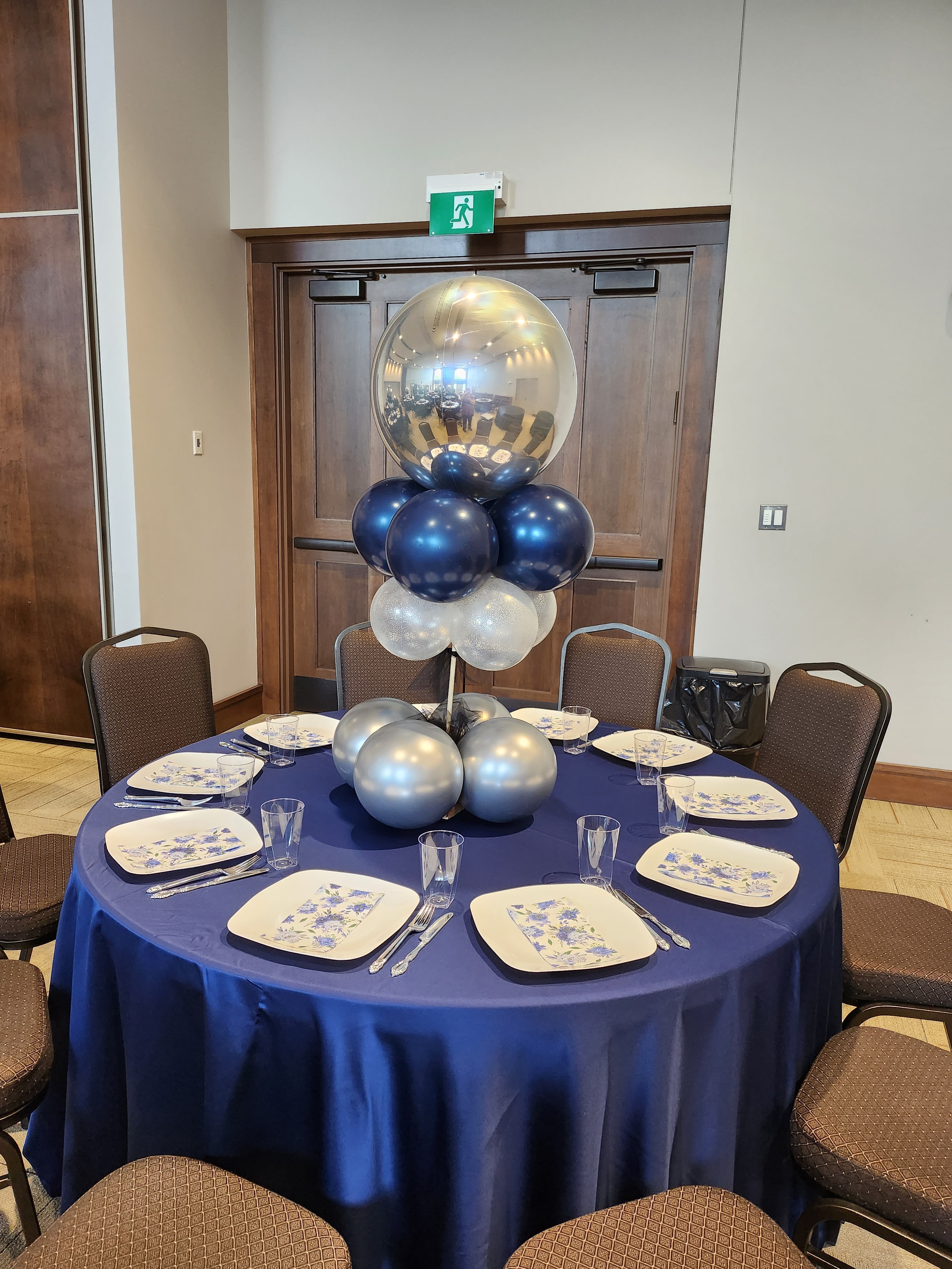 Navy and silver balloon centrepiece at event table