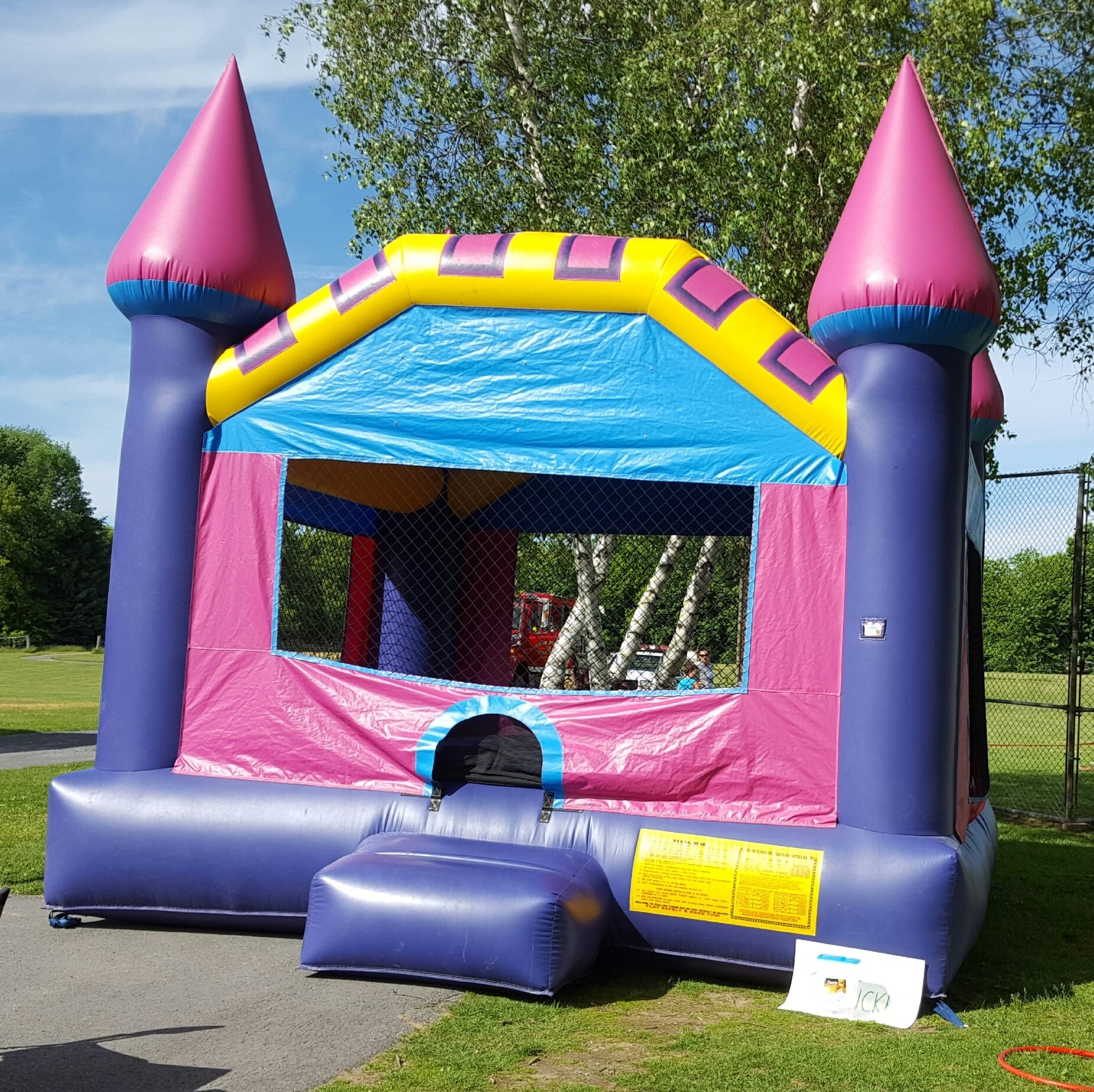 Pink and purple bounce castle set up outdoors