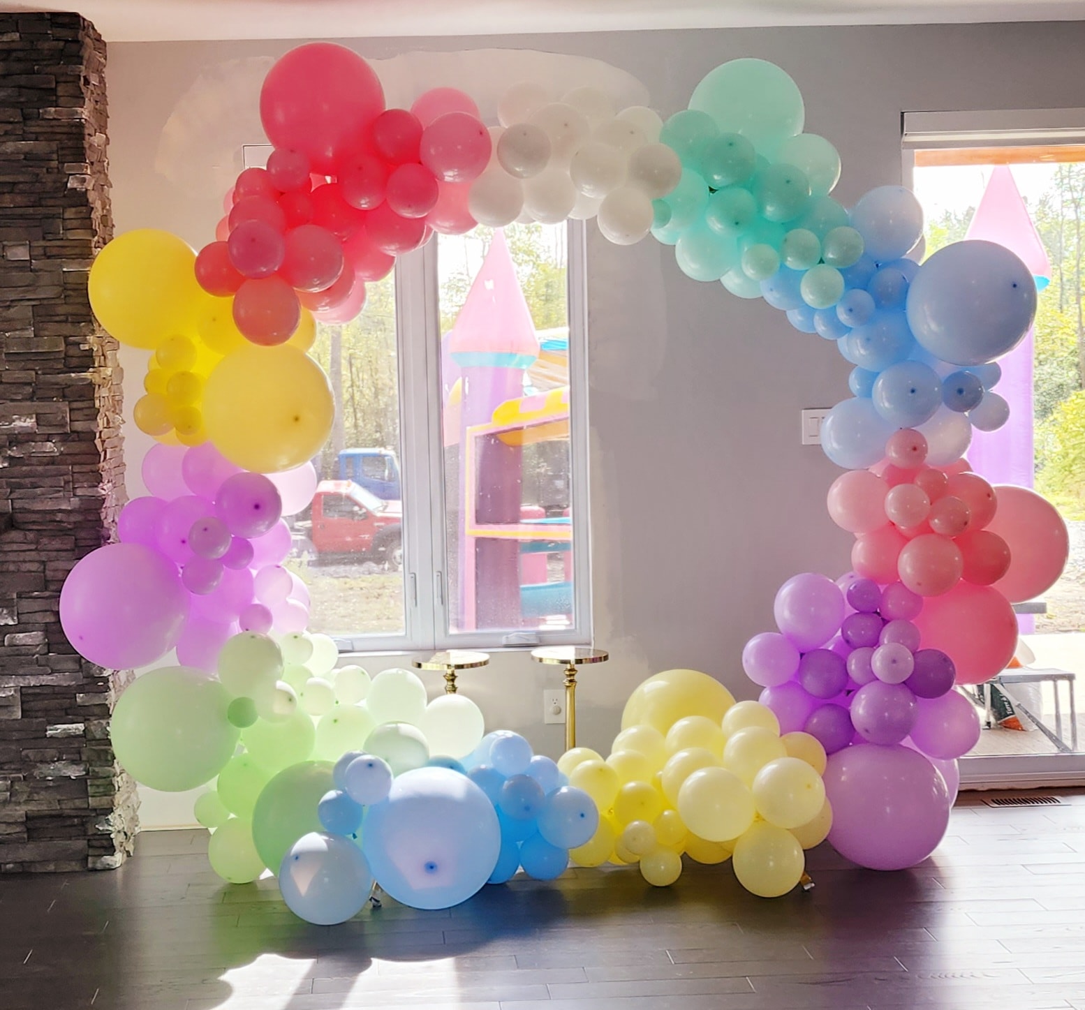 Rainbow balloon arch in pastel colours indoors