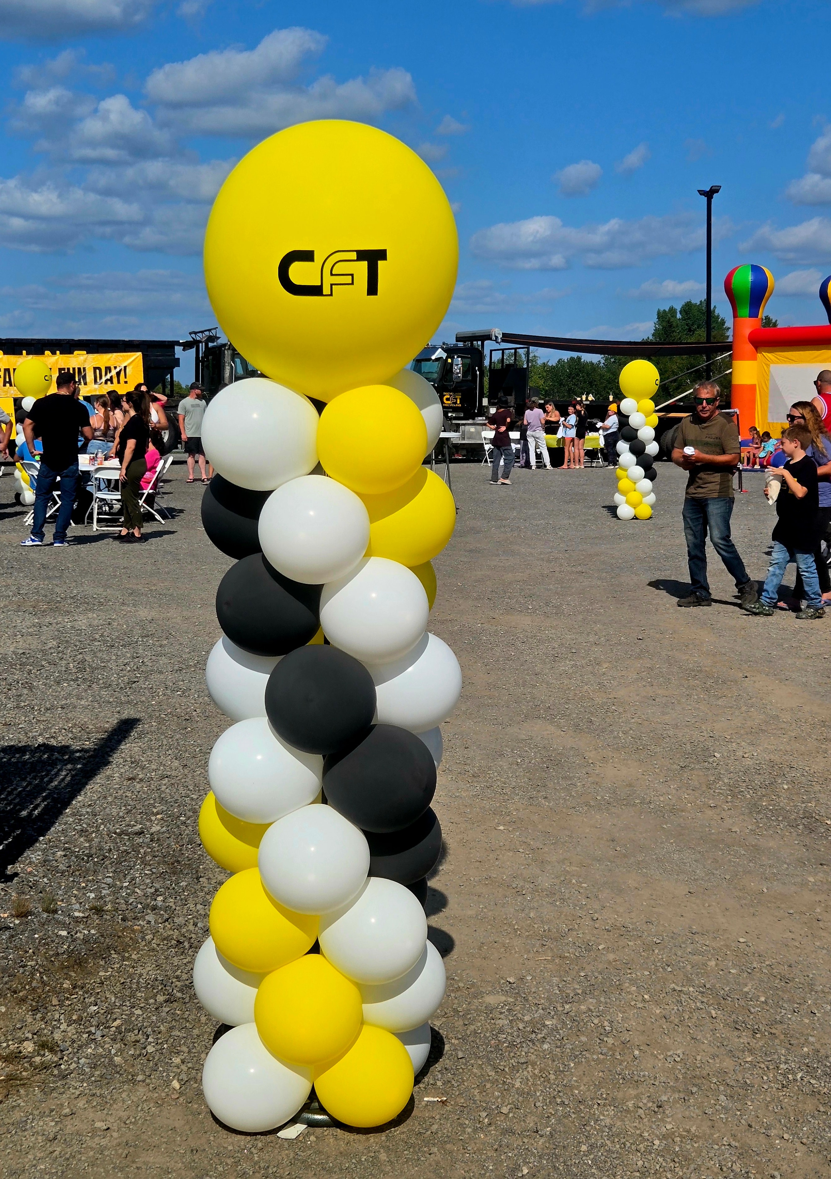 CFT branded balloon column at outdoor company fun day event